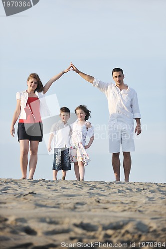 Image of family on beach showing home sign