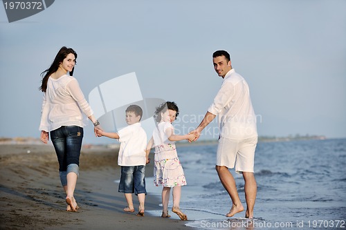 Image of happy young family have fun on beach