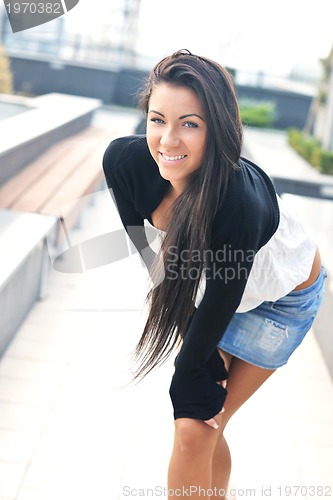 Image of beautiful young lady posing in garden