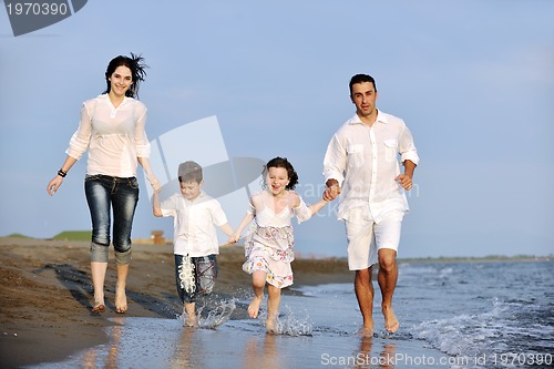 Image of happy young family have fun on beach