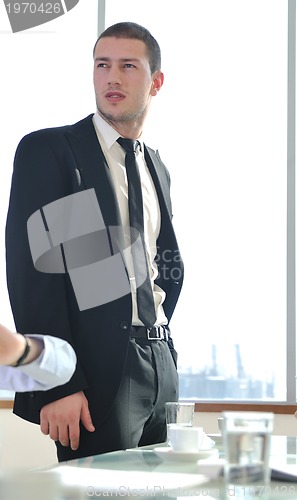 Image of young business man alone in conference room