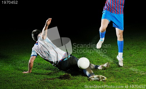 Image of football players in competition for the ball