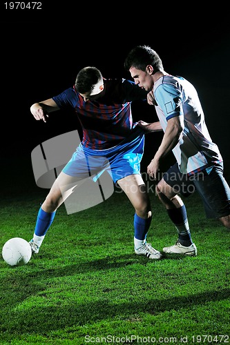 Image of football players in competition for the ball