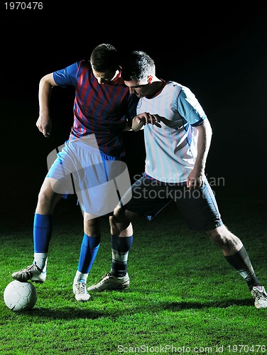 Image of football players in competition for the ball