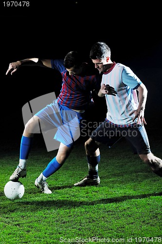 Image of football players in competition for the ball