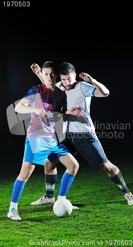 Image of football players in competition for the ball