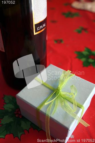 Image of Christmas celebration with good wine and gift box