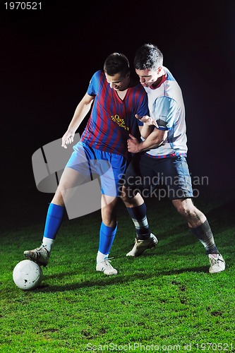 Image of football players in competition for the ball