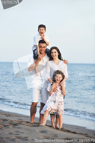 Image of happy young family have fun on beach