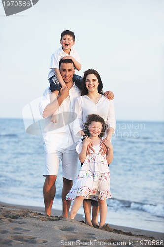Image of happy young family have fun on beach