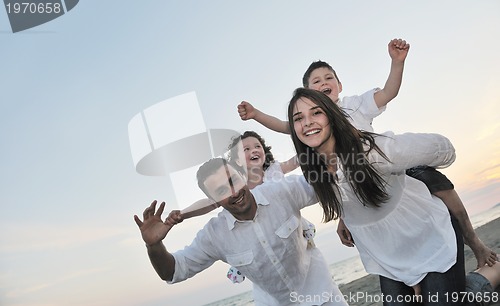 Image of happy young family have fun on beach