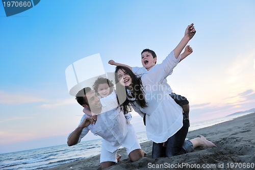 Image of happy young family have fun on beach