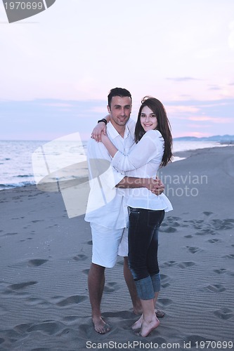 Image of happy young couple have fun on beach