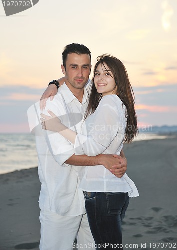 Image of happy young couple have fun on beach