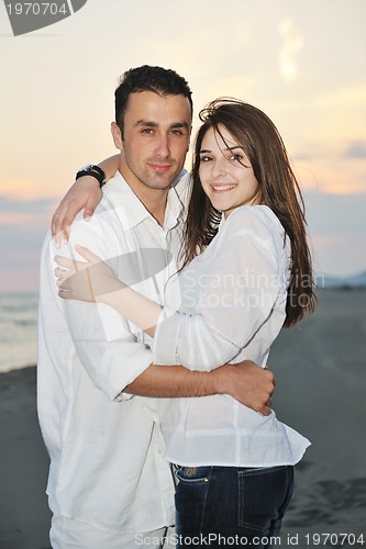 Image of happy young couple have fun on beach