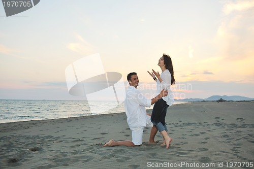 Image of happy young couple have fun on beach