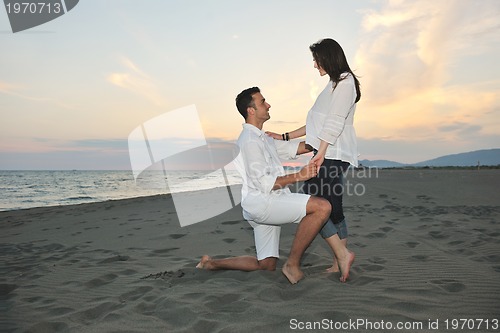 Image of happy young couple have fun on beach