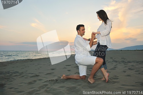 Image of happy young couple have fun on beach