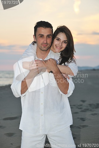 Image of happy young couple have fun on beach