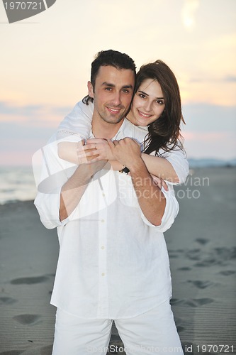 Image of happy young couple have fun on beach