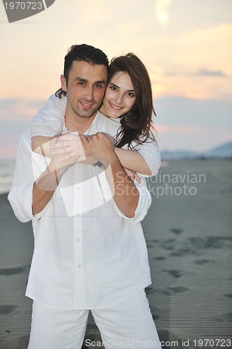 Image of happy young couple have fun on beach