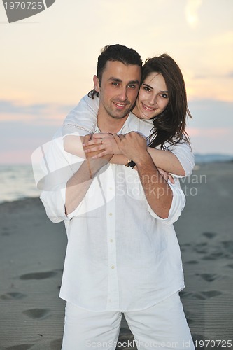 Image of happy young couple have fun on beach