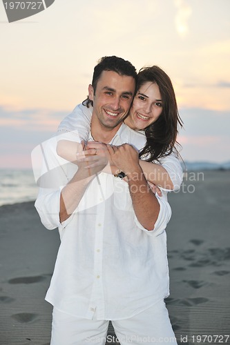 Image of happy young couple have fun on beach