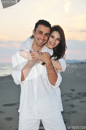 Image of happy young couple have fun on beach