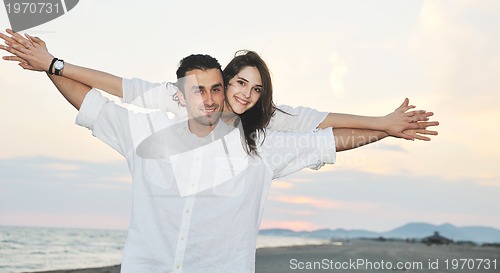 Image of happy young couple have fun on beach