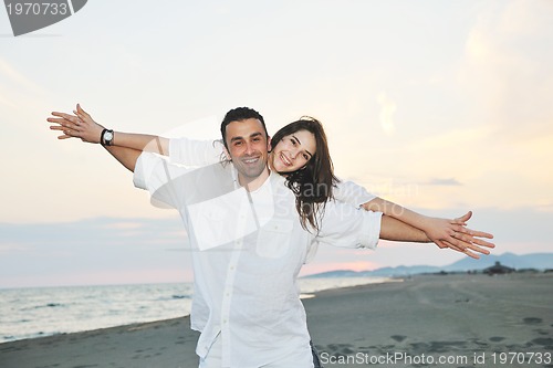 Image of happy young couple have fun on beach