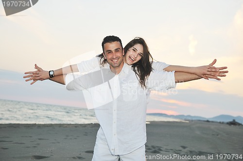 Image of happy young couple have fun on beach