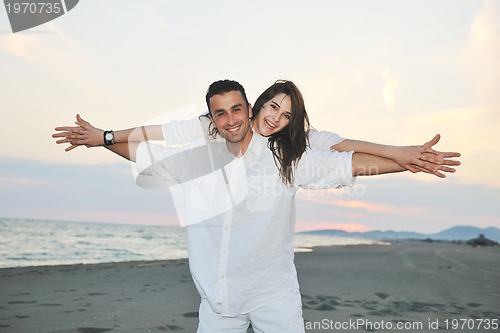 Image of happy young couple have fun on beach