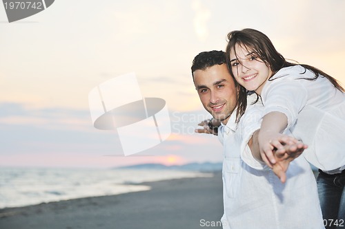Image of happy young couple have fun on beach