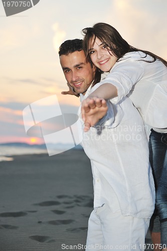 Image of happy young couple have fun on beach