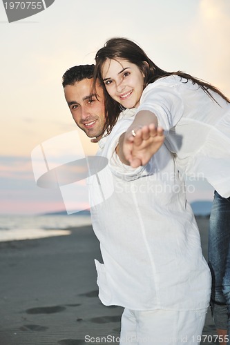 Image of happy young couple have fun on beach