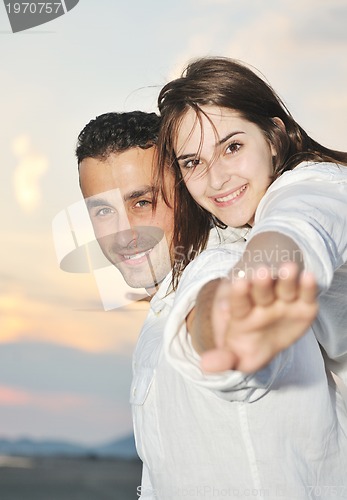 Image of happy young couple have fun on beach