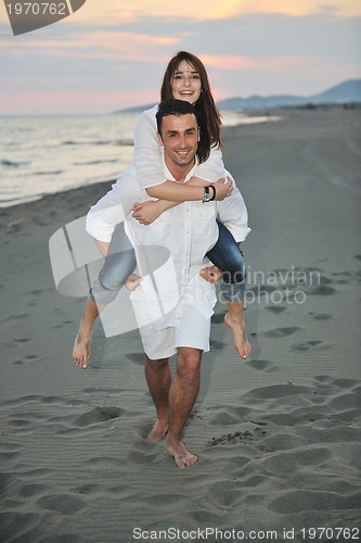 Image of happy young couple have fun on beach