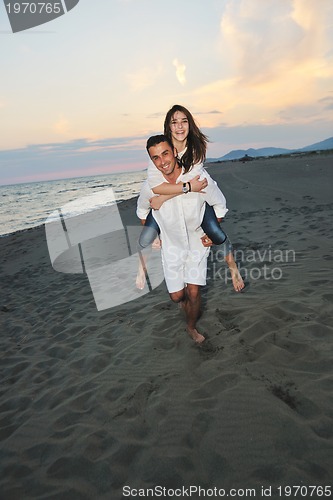 Image of happy young couple have fun on beach