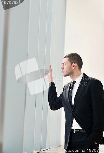 Image of young business man alone in conference room