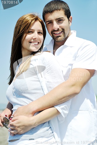 Image of happy young couple have fun on beach