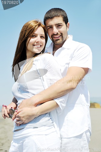 Image of happy young couple have fun on beach