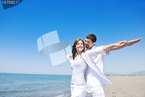 Image of happy young couple have fun on beach