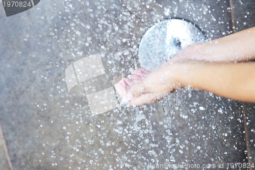 Image of sexy young woman enjoing bath under water shower