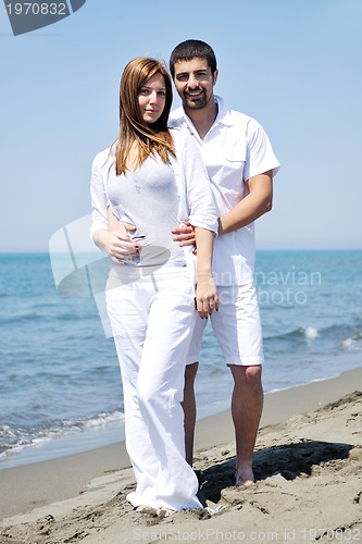 Image of happy young couple have fun on beach