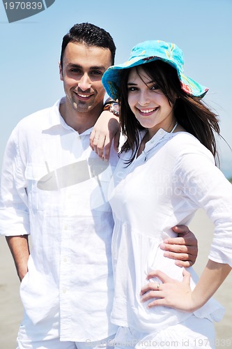 Image of happy young couple have fun on beach