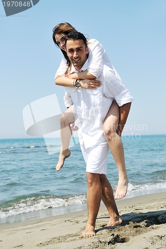 Image of happy young couple have fun on beach