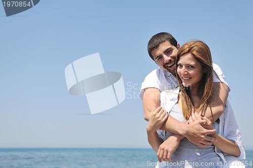 Image of happy young couple have fun on beach