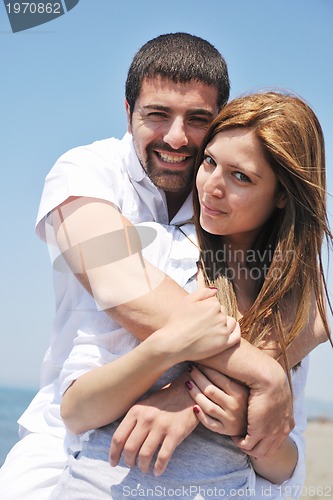 Image of happy young couple have fun on beach