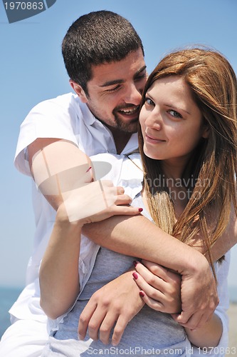 Image of happy young couple have fun on beach