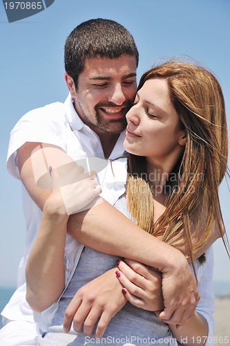Image of happy young couple have fun on beach
